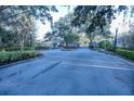 Gated community entrance with landscaping and street at 1604 Boswell Ln, New Port Richey, FL 34655