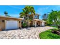 Two-story house with a large driveway and garage at 16301 Redington Dr, Redington Beach, FL 33708