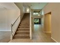 Two-story foyer with a staircase and tile floors at 2203 Preservation Dr, Plant City, FL 33566