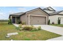 One-story home with a two-car garage and landscaped front yard at 30148 Fedora Cir, Brooksville, FL 34602