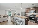 Open concept kitchen with island, stainless steel appliances, and granite countertops at 30148 Fedora Cir, Brooksville, FL 34602