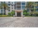 Modern building exterior with palm trees and paved courtyard at 331 Cleveland St # 315, Clearwater, FL 33755