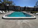 Relaxing community pool with lounge chairs at 3987 Maceachen Blvd # 133, Sarasota, FL 34233