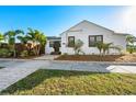 White bungalow with palm trees and a paved walkway at 4563 3Rd S Ave, St Petersburg, FL 33711