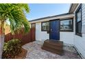 Front entrance with blue door and brick patio at 4563 3Rd S Ave, St Petersburg, FL 33711