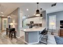 Modern kitchen with white cabinets, quartz countertops, and island at 5610 Golden Isles Dr, Apollo Beach, FL 33572