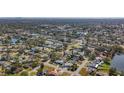 Aerial perspective of houses, roads, and a lake in a community at 6008 49Th N Ave, Kenneth City, FL 33709