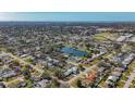 Aerial view of a residential neighborhood near a lake at 6008 49Th N Ave, Kenneth City, FL 33709