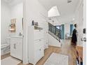 Bright and airy entryway with half bathroom and staircase at 8709 Palm Ranches Pl, Tampa, FL 33614