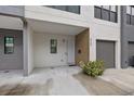 Front view of townhome with a gray and white color scheme at 8709 Palm Ranches Pl, Tampa, FL 33614