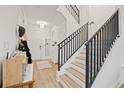 Modern staircase with black metal railings leading to the second floor at 8709 Palm Ranches Pl, Tampa, FL 33614