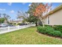 Landscaped yard with a white picket fence at 10002 Bentley Way, Tampa, FL 33626