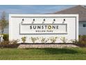 Sunstone Wellen Park community entrance sign with white brick and landscaping at 12199 Meditation Trl, Venice, FL 34293