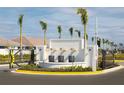 Modern gated community entrance with water feature and palm trees at 12199 Meditation Trl, Venice, FL 34293
