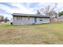 House exterior showcasing gray siding and a grassy yard at 14430 10Th. St, Dade City, FL 33523