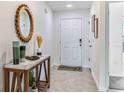 Bright and airy entryway with a wooden console table and a large mirror at 1714 Tahitian Sunrise Dr, Plant City, FL 33565