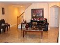 Living room with a cozy leather couch and a staircase at 17346 Mint Leaf Ln, Land O Lakes, FL 34638