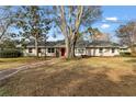 Charming ranch home with brick walkway and large tree at 1758 Winfield Cir, Clearwater, FL 33756