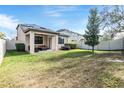 Spacious backyard with covered patio, hot tub, and grassy area at 18811 Deer Tracks Loop, Lutz, FL 33558