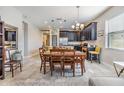 Open dining area with wooden table and chairs, adjacent to kitchen at 18811 Deer Tracks Loop, Lutz, FL 33558