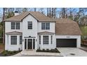 Two-story white brick house with dark brown garage door and landscaping at 19018 Geraci Rd, Lutz, FL 33548