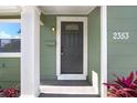 Dark gray front door entry with glass accents and white columns at 2353 Grove S St, St Petersburg, FL 33705