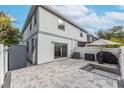 Private backyard patio with pavers, grill, and string lights at 2704 W Gray St # B, Tampa, FL 33609