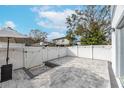 Backyard patio with pavers, white fence, and string lights at 2704 W Gray St # B, Tampa, FL 33609