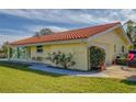 Ranch style home with tile roof and spacious lawn at 2801 Hibiscus W Dr, Belleair Beach, FL 33786