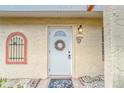 White front door with wreath, showcasing condo entry at 401 Dorchester Pl # 52, Sun City Center, FL 33573