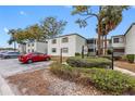 The Vineyard Condominium building, showcasing a parking area and landscaping at 4611 W North B St # 129, Tampa, FL 33609