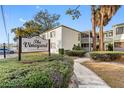 The Vineyard Condominium building, with palm trees and a sign at 4611 W North B St # 129, Tampa, FL 33609