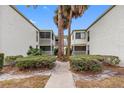 Back view of the Vineyard Condominium building, showing a courtyard and walkways at 4611 W North B St # 129, Tampa, FL 33609