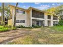 Building exterior showcasing a beige color scheme and lush landscaping at 6012 Laketree Ln # A, Temple Terrace, FL 33617