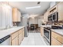 Galley kitchen with stainless steel appliances at 7800 Kay Marie Ave, Zephyrhills, FL 33541