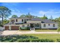Luxury two-story home with a three-car garage and landscaped yard at 9050 San Martin Ne Blvd, St Petersburg, FL 33702