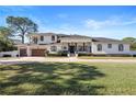 Beautiful two-story house with a three-car garage and lush lawn at 9050 San Martin Ne Blvd, St Petersburg, FL 33702