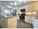 Modern kitchen with stainless steel appliances and granite countertops at 106 1St E St # 115, St Petersburg, FL 33715