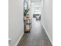 Bright entryway with dark wood-look floors and a console table at 11654 Stone Pine St, Riverview, FL 33569