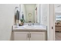 Small powder room with a pedestal sink and white cabinets at 11654 Stone Pine St, Riverview, FL 33569