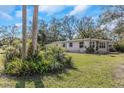 Single story home with front yard landscaping at 1619 E Nome St, Tampa, FL 33604