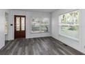 Bright living room featuring grey flooring and large windows at 1619 E Nome St, Tampa, FL 33604