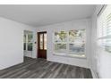 Bright living room featuring grey flooring and large windows at 1619 E Nome St, Tampa, FL 33604