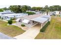 Attractive manufactured home with carport and surrounding homes visible at 36900 Grace Ave, Zephyrhills, FL 33542