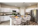 Modern kitchen with white cabinets, stainless steel appliances, and an island at 37268 Sagemoor Dr, Zephyrhills, FL 33541