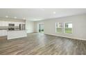 Spacious living area with wood-look floors and access to backyard at 37306 Sagemoor Dr, Zephyrhills, FL 33541