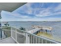 Balcony view overlooking a tranquil waterfront scene at 464 N Paula Dr # 220, Dunedin, FL 34698