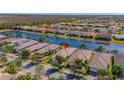 Aerial view of property showcasing the community and lake at 4846 Sandy Glen Way, Wimauma, FL 33598