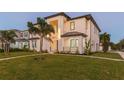 Modern two-story home with a landscaped lawn and walkway at 716 S Lois Ave, Tampa, FL 33609