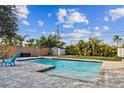 Inviting L-shaped pool with a large patio great for entertaining at 7405 41St Ave N, St Petersburg, FL 33709